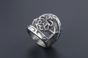 Macro detail of vintage stainless steel wide ring with Kokopelli and star engravings
