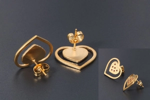 Detailed view of gold heart stud earring with red zircon inlay and butterfly backing