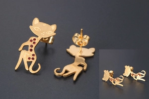 Macro shot of 18K rose gold plated cat stud earrings with sparkling red rhinestone accents