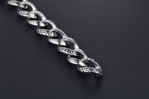 Macro detail of gothic snake skin pattern on silver stainless steel bracelet links