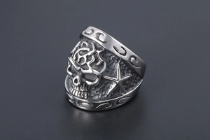 Macro shot of punk style stainless steel skull ring with embossed star patterns
