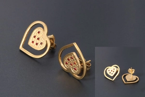 Detail of 18K gold heart studs with textured inner layer and red crystals inlay