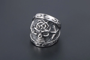 Macro shot of gothic skull relief on vintage steel ring with intricate star patterns