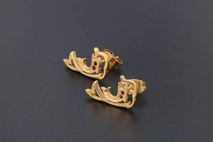 Macro shot of dolphin earrings in 18K gold plating with sparkling red crystal accents