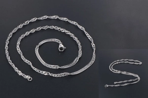 Close-up of silver water wave chain necklace with detailed spiral twist and lobster clasp