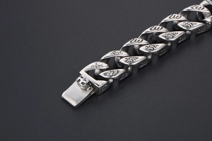 Macro shot of punk retro stainless steel bracelet with engraved Buddhist symbols