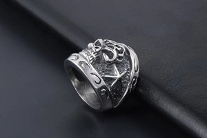 Detailed close-up of retro stainless steel skull ring with embossed star and floral patterns