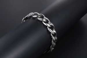 Macro view of gothic snake scale texture on vintage stainless steel chain bracelet