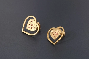 Detail of 18K gold-plated heart earrings with red crystal inlay on gray background