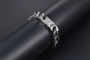 Detail of punk retro titanium steel bracelet featuring interlocking rings and etched icons