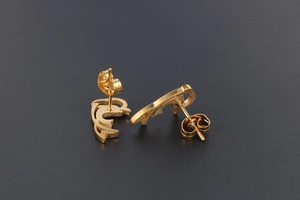 Detail view of 18K gold plated dolphin stud earrings with matte finish and butterfly backings