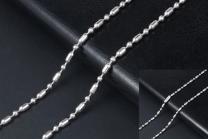Détail macro d'une chaîne à maillons bambou en acier inoxydable sur cuir noir