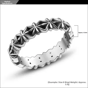 Detailed macro view of silver geometric star patterns on a 4.5mm wide textured metal ring