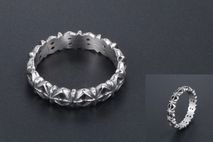Close-up of vintage silver ring featuring cross relief and inner circular hole patterns