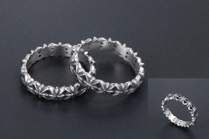 Close-up of vintage silver rings with Gothic cross patterns and metallic texture