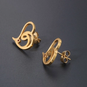 Elegant gold titanium heart stud earrings with small red zircon stone on dark background