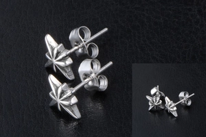 Macro shot of vintage silver octagonal star stud earrings with brushed metal texture