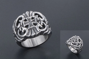 Detailed view of vintage gothic steel ring featuring cross relief and scrollwork patterns