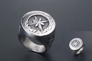 Macro view of silver signet ring with engraved star compass and Celtic knot details
