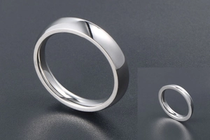 Macro shot of polished silver stainless steel ring showing reflective mirror finish