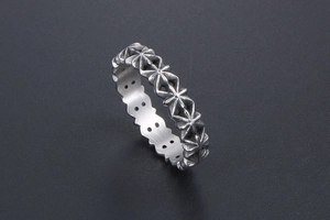 Macro view of vintage silver ring with relief cross star pattern and aged metal texture