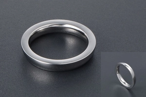 Detailed close-up of polished silver stainless steel ring with smooth metallic surface