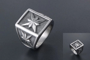 Macro view of vintage stainless steel signet ring with engraved octagonal star design