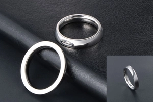 Detailed view of polished silver titanium steel minimalist band rings on leather background