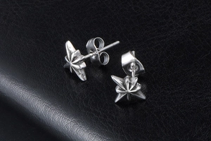 Macro shot of 3D octagonal star stud earrings in vintage silver stainless steel