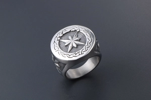 Detail view of retro silver signet ring featuring 3D star compass and rope texture