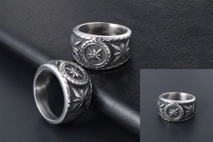 Detailed macro view of vintage stainless steel rings with embossed star and compass motifs