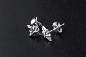 Macro detail of silver star stud earrings with vintage finish and butterfly backings