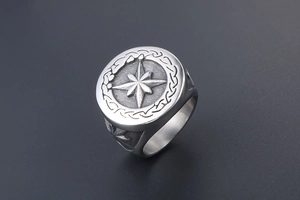 Detail of vintage silver octagonal star signet ring with nautical compass relief