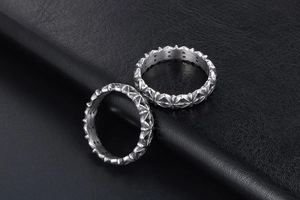 Macro shot of silver retro rings with star geometric relief on black leather