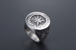 Macro view of vintage silver ring with eight-pointed star relief and Celtic patterns