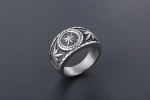 Macro detail of silver vintage punk ring with embossed octagonal star and oxidized finish
