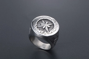 Detail view of vintage octagonal star ring with Celtic knot textures and silver finish