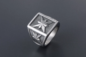Macro shot of vintage titanium steel signet ring with engraved compass star pattern