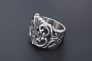Macro view of retro hollow stainless steel ring with gothic cemetery cross pattern