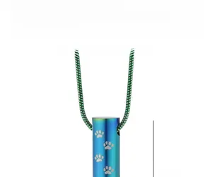 Iridescent cylinder cremation pendant with silver paw prints and green snake chain