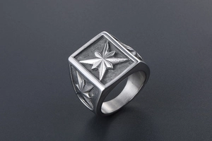 Macro shot of silver titanium steel signet ring with embossed star and vintage finish