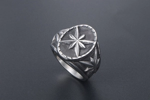 Détail d'une bague vintage en acier argenté avec motif d'étoile à huit branches