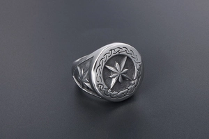 Close-up of vintage star signet ring with Celtic knot patterns and matte oxidized finish
