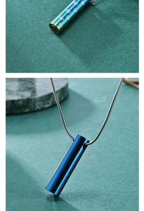 Detail of cylinder cremation pendants in blue and rainbow finish with paw prints