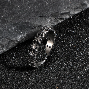 Vintage oxidized silver ring featuring industrial star engraving on textured rock