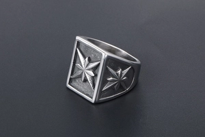 Detail of signet ring with engraved compass star patterns and vintage silver finish