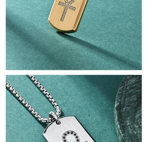 Detailed macro view of Ankh pendants with cubic zirconia inlay on a textured background
