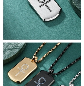 Detail of Ankh pendant necklaces in gold, silver, and black with stone-set embellishments