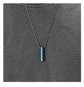 Detail of blue gradient urn pendant with white paw print on grey knit background