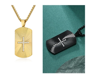 Detail of cross dog tag pendants with sunburst texture and inlaid stones in gold and black